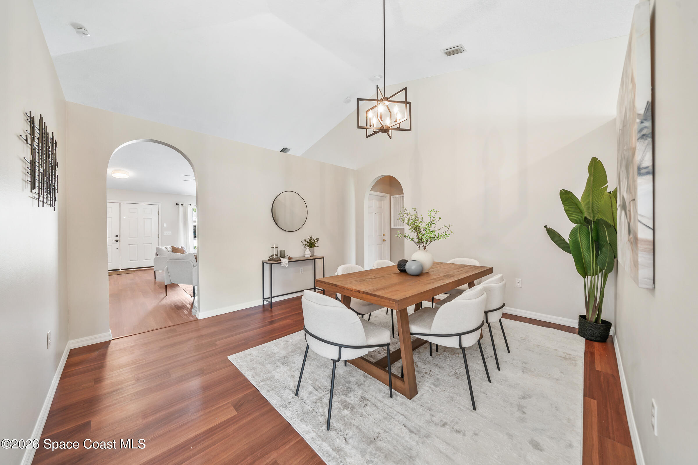 332 Brookcrest Circle Rockledge, FL 32955 - Photo 16 of 38 a dining room with furniture a chandelier and wooden floor