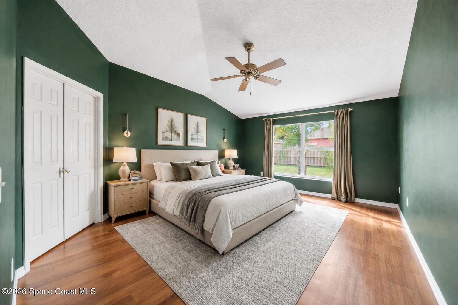 332 Brookcrest Circle Rockledge, FL 32955 - Photo 19 of 38 a spacious bedroom with a large bed and a chandelier