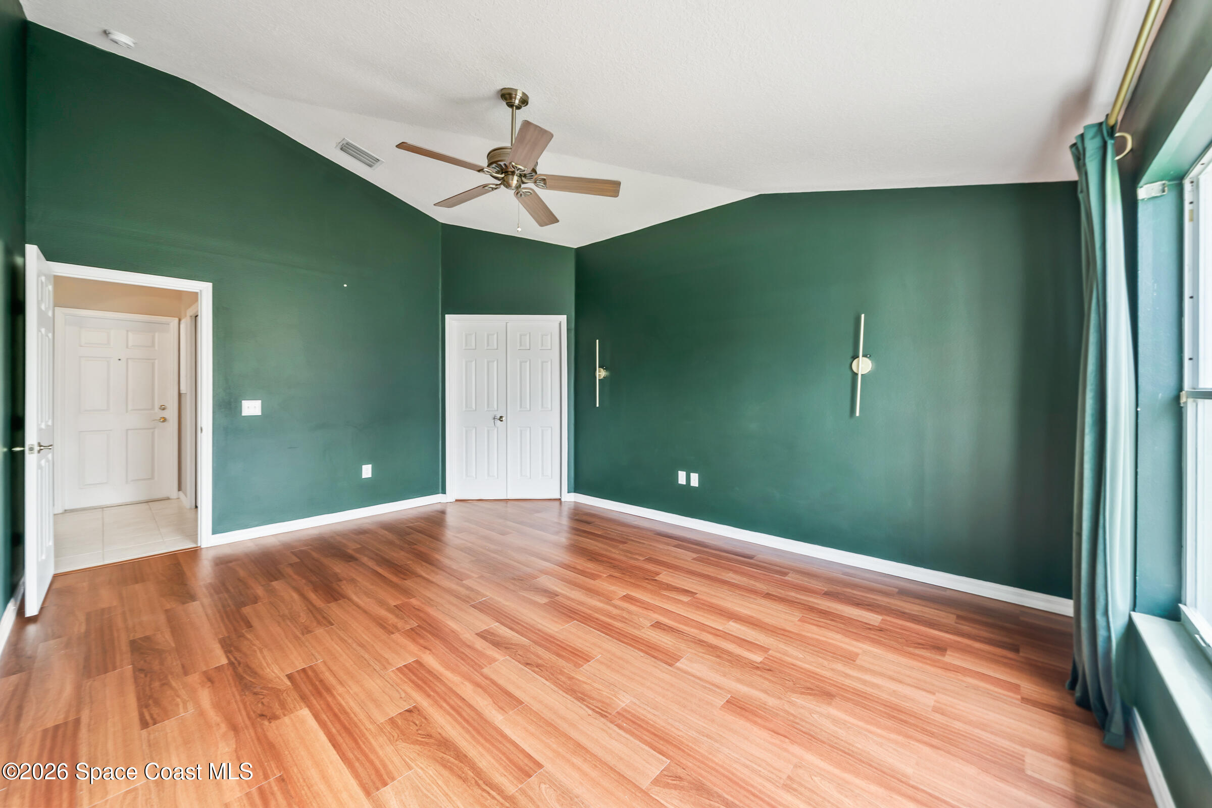 332 Brookcrest Circle Rockledge, FL 32955 - Photo 21 of 38 a view of a big room with a chandelier fan and hardwood floor