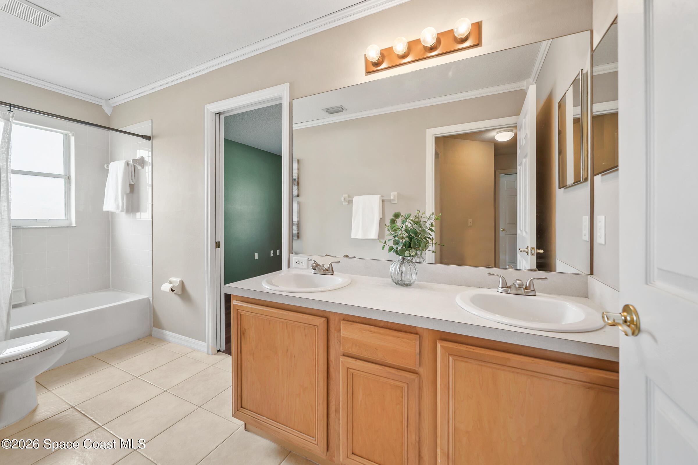 332 Brookcrest Circle Rockledge, FL 32955 - Photo 30 of 38 a bathroom with a sink and a mirror