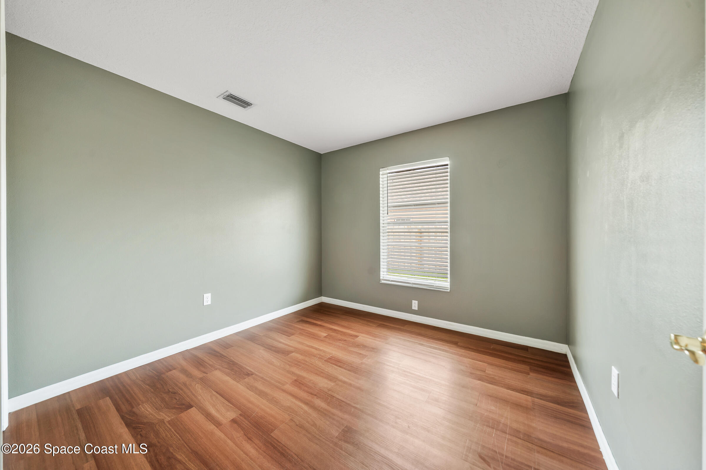 332 Brookcrest Circle Rockledge, FL 32955 - Photo 34 of 38 an empty room with wooden floor and windows