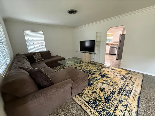 a living room with a couch and a flat screen tv