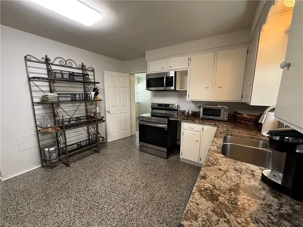 a kitchen with appliances cabinets and a counter top space