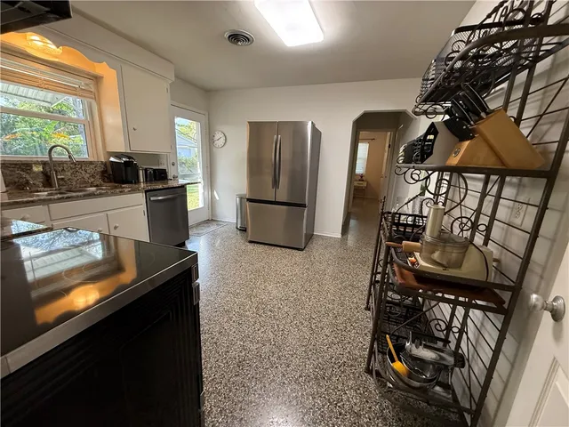 a kitchen with sink cabinets and stainless steel appliances