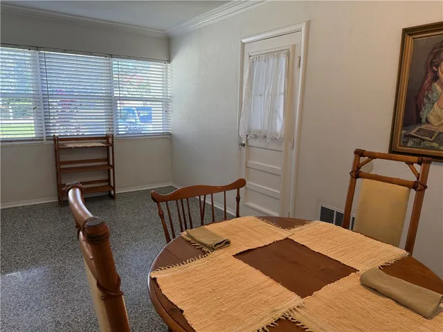 a bedroom with a bed next to a window