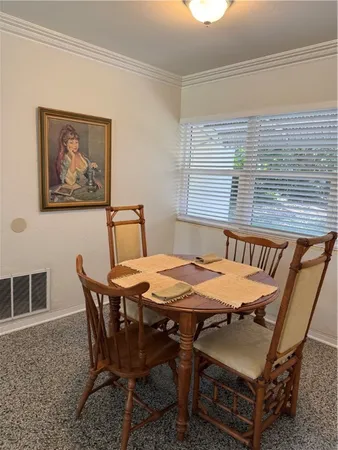 a view of a dining room with furniture and window