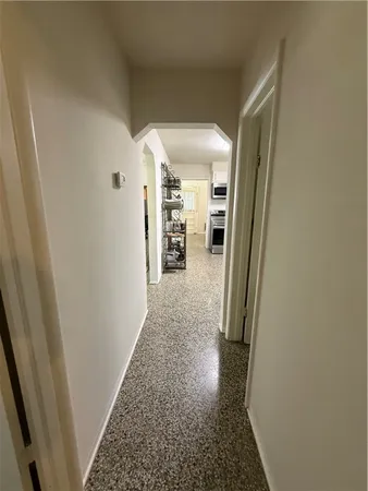 a view of hallway with wooden floor
