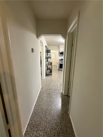 a view of hallway with wooden floor