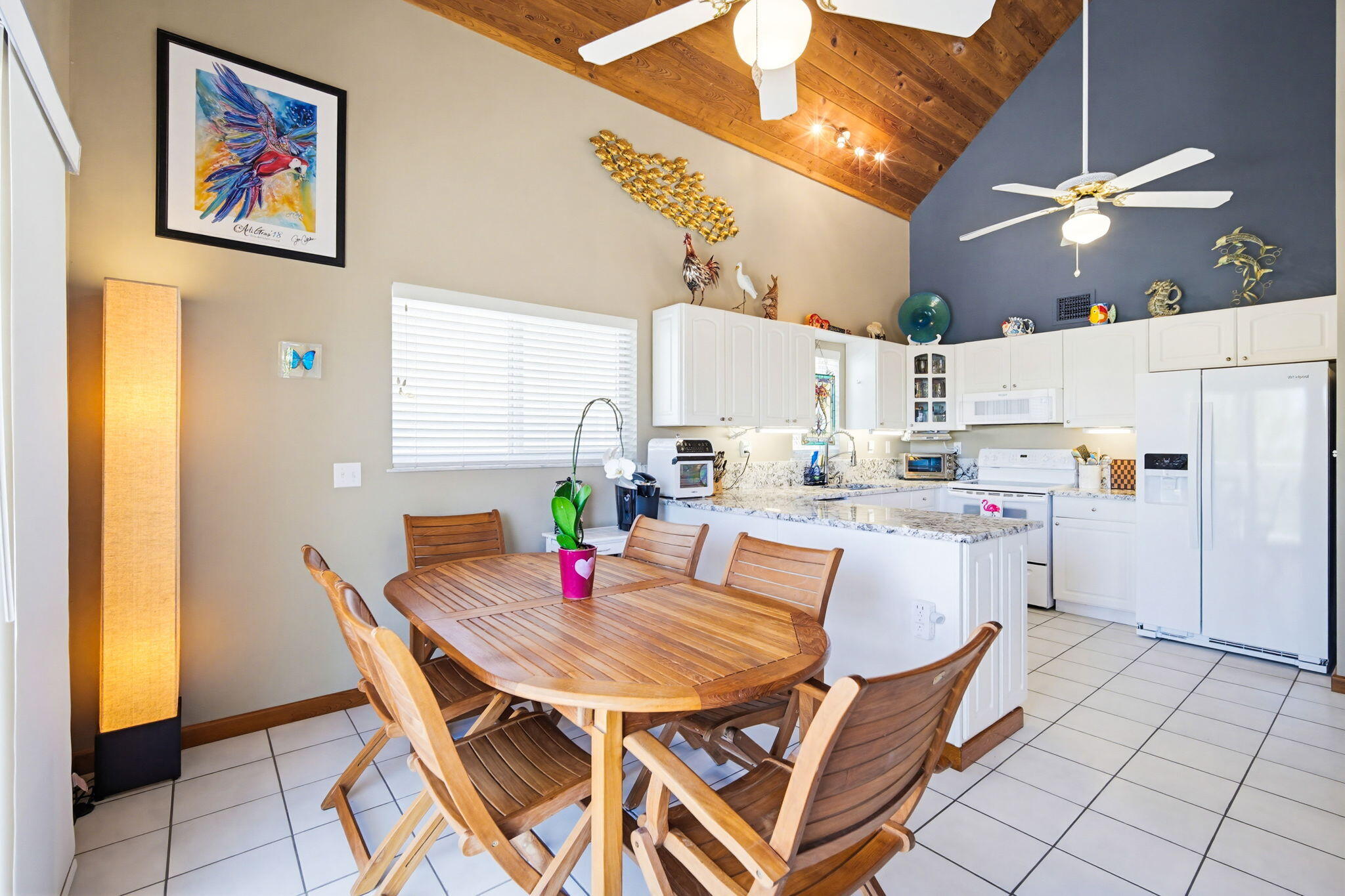 612 Blackbeard Road Summerland Key, FL 33042 - Photo 19 of 68 a dining room with kitchen island a table and chairs in it