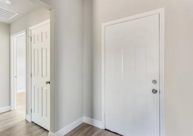 a view of kitchen with granite countertop cabinets and white appliances