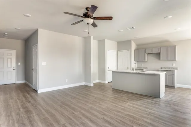 a view of kitchen with sink microwave and refrigerator