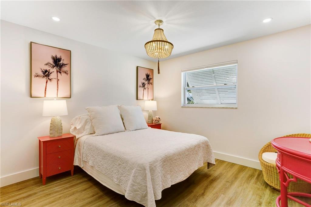 1793 Smugglers Cove, Unit B Naples, FL 34112 - Photo 13 of 24 a bedroom with a bed and a window