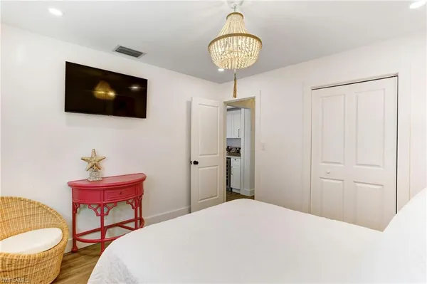 a bedroom with a bed and a potted plant