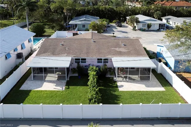 an aerial view of a house with garden space and sitting area