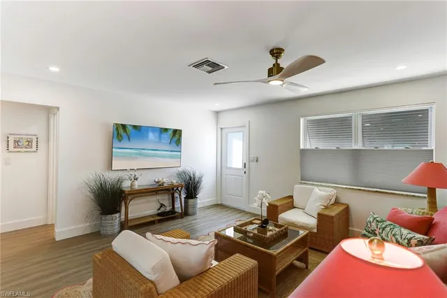 a living room with furniture and a wooden floor