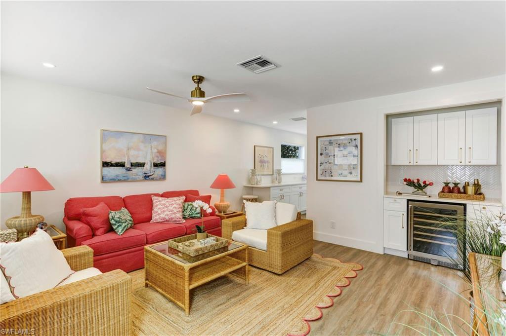 1793 Smugglers Cove, Unit B Naples, FL 34112 - Photo 4 of 24 a living room with furniture and a wooden floor