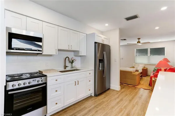 a kitchen with stainless steel appliances a stove microwave and cabinets