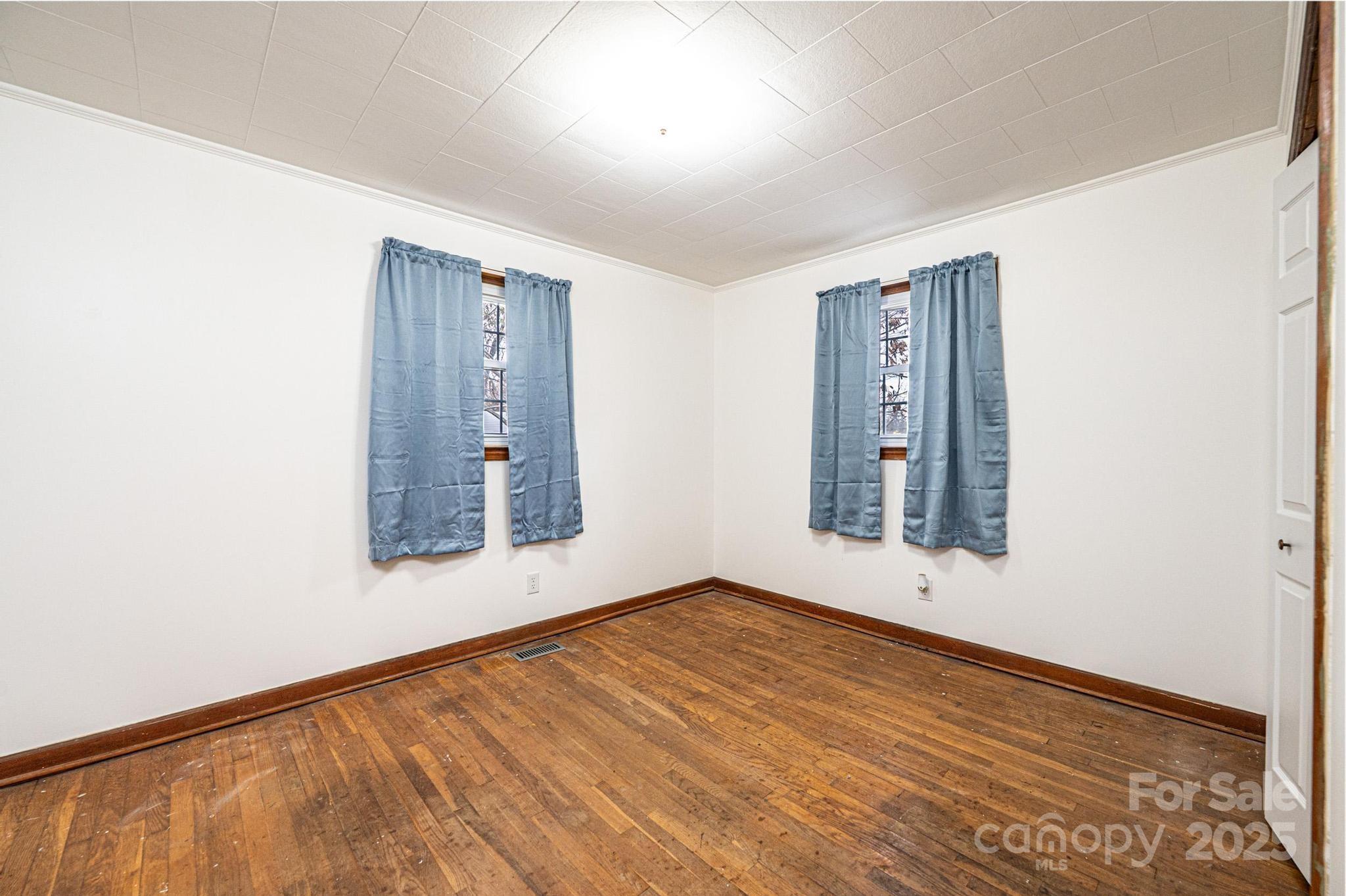 1214 Dry Ponds Road Granite Falls, NC 28630 - Photo 18 of 39 a view of an empty room with wooden floor and a window
