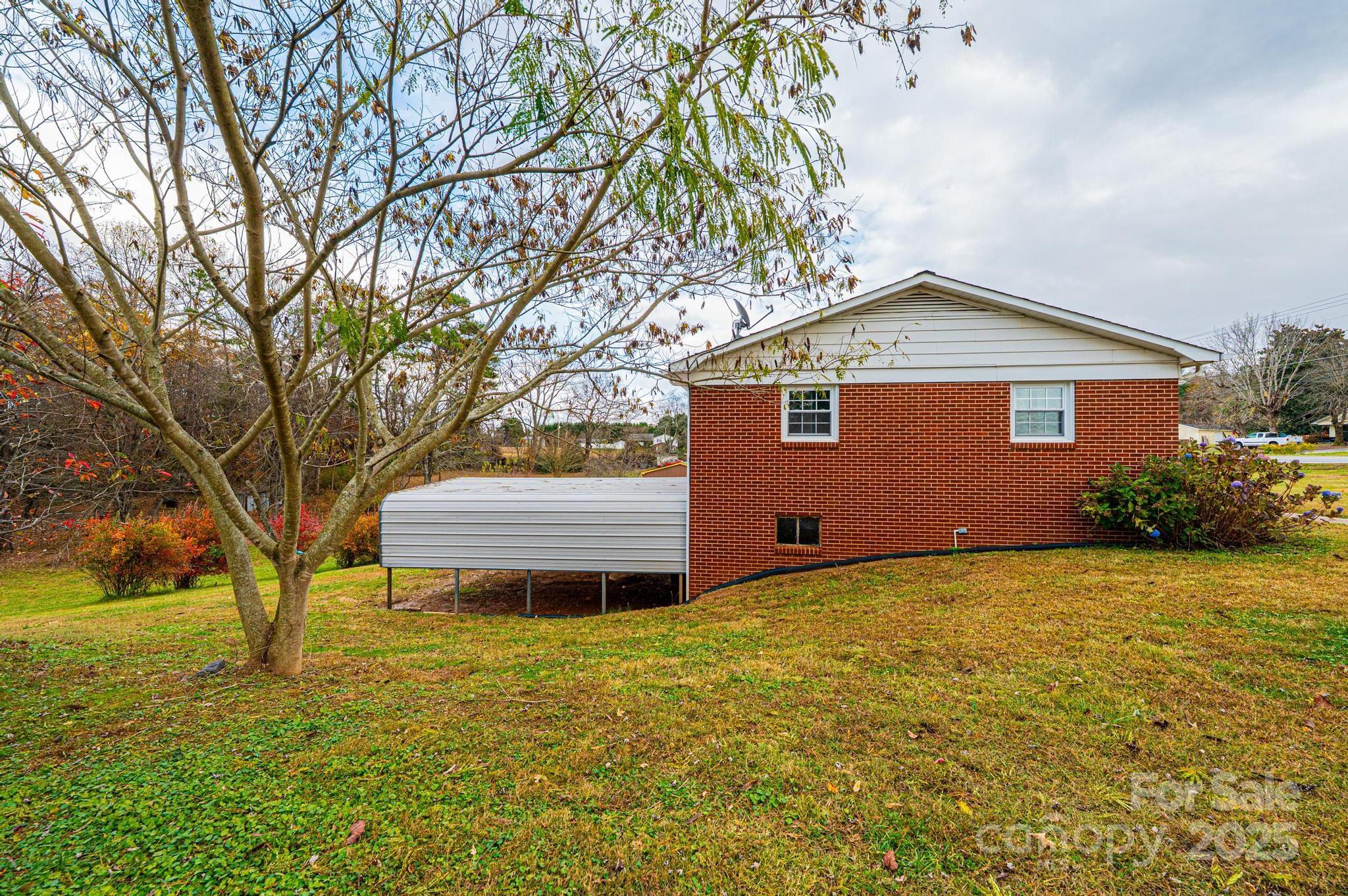 1214 Dry Ponds Road Granite Falls, NC 28630 - Photo 25 of 39 a front view of house with yard and trees in the background