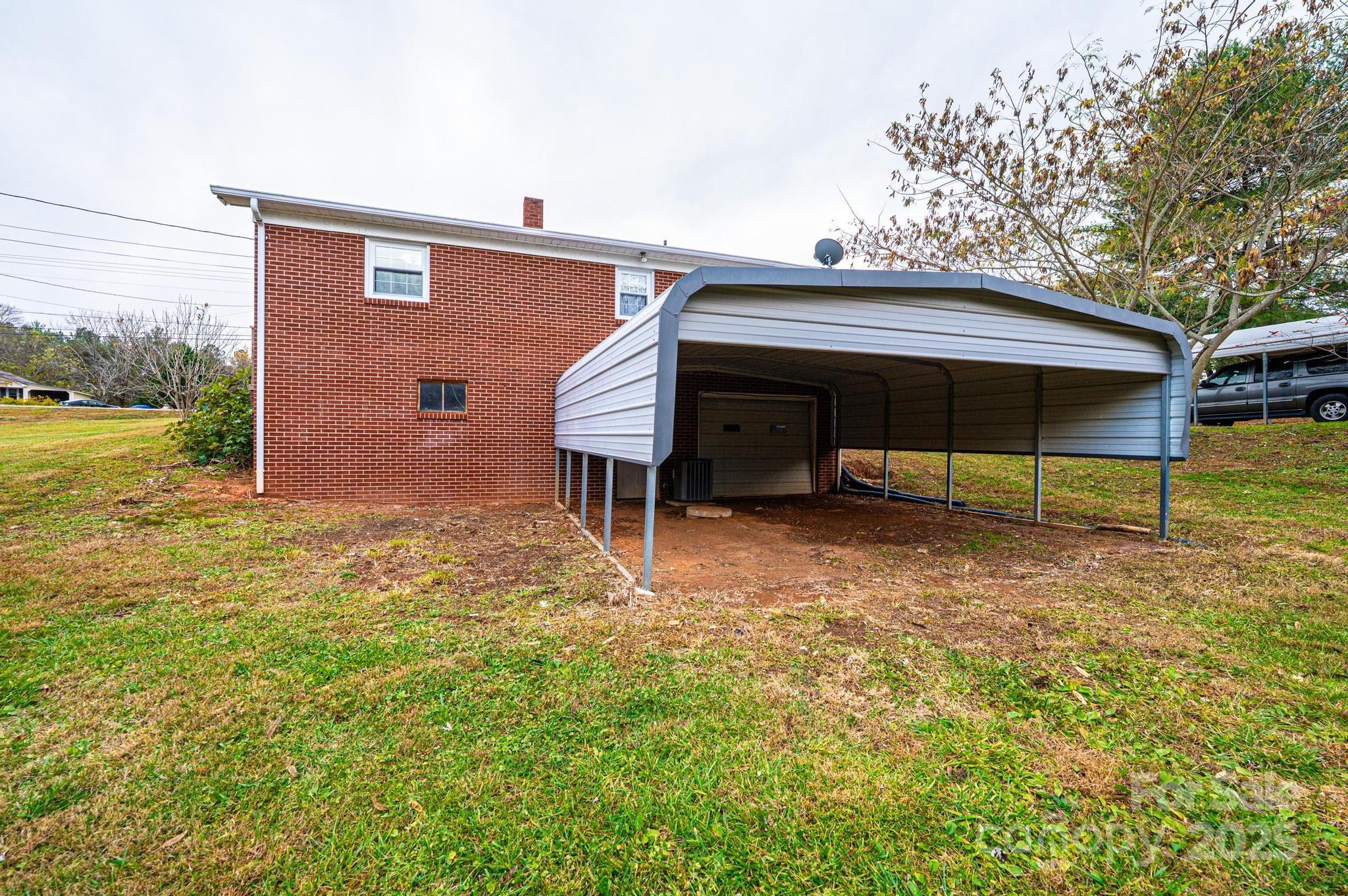 1214 Dry Ponds Road Granite Falls, NC 28630 - Photo 29 of 39 a view of backyard with wooden fence and large trees