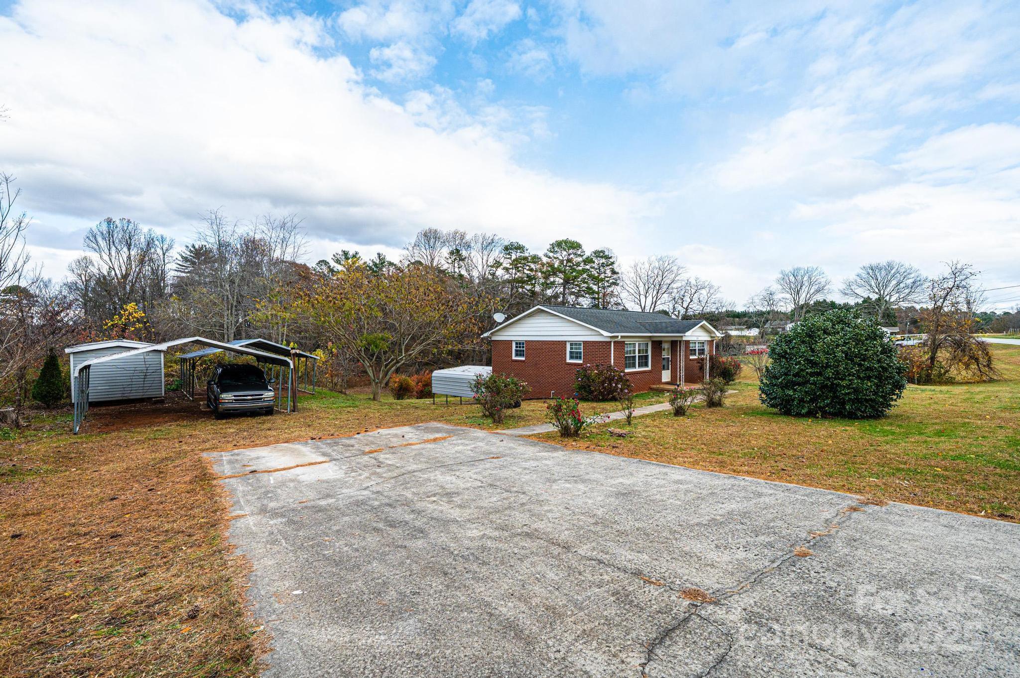 1214 Dry Ponds Road Granite Falls, NC 28630 - Photo 39 of 39 a front view of a house with a yard and garage