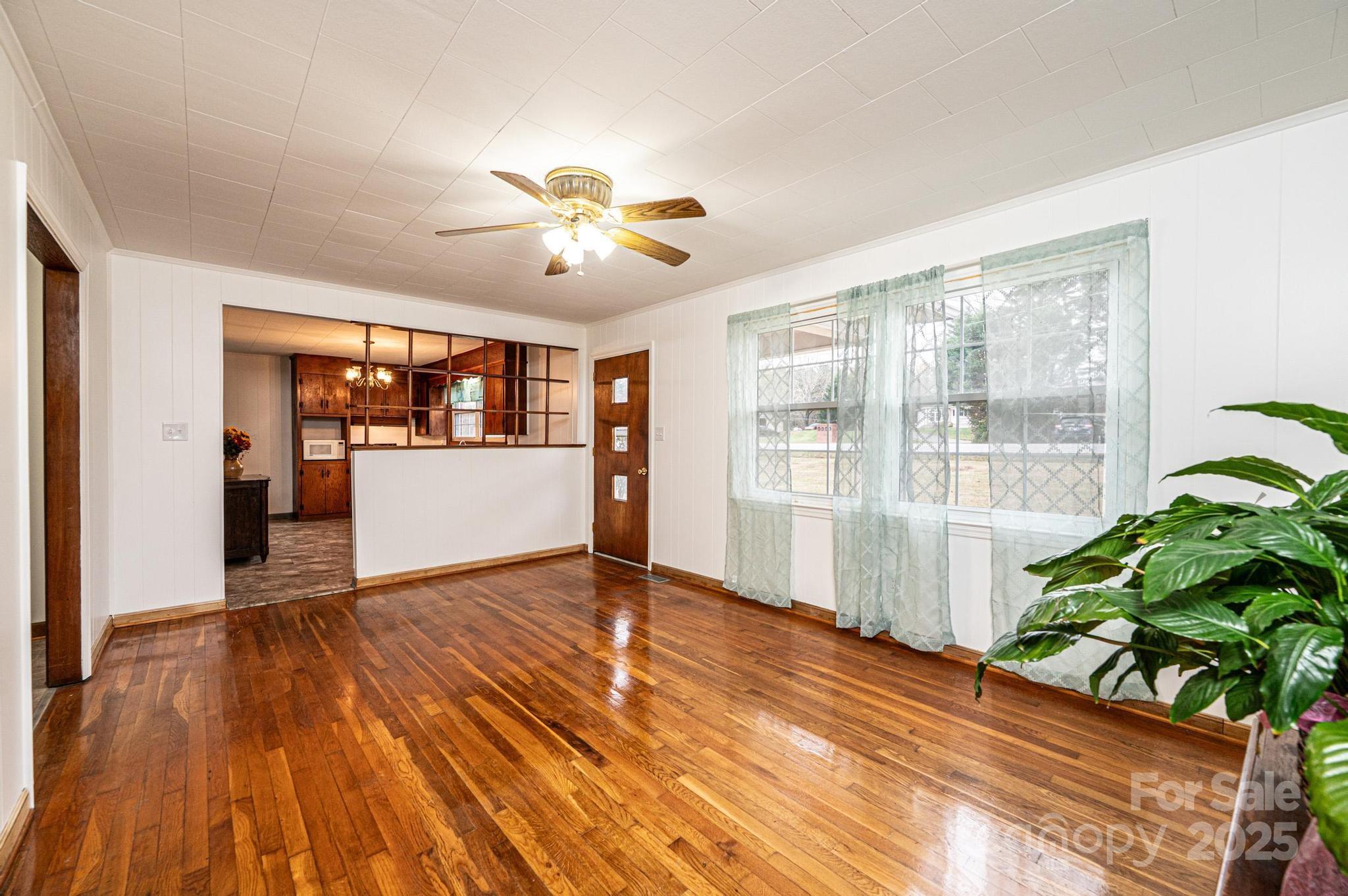 1214 Dry Ponds Road Granite Falls, NC 28630 - Photo 5 of 39 a view of an empty room with wooden floor and a window