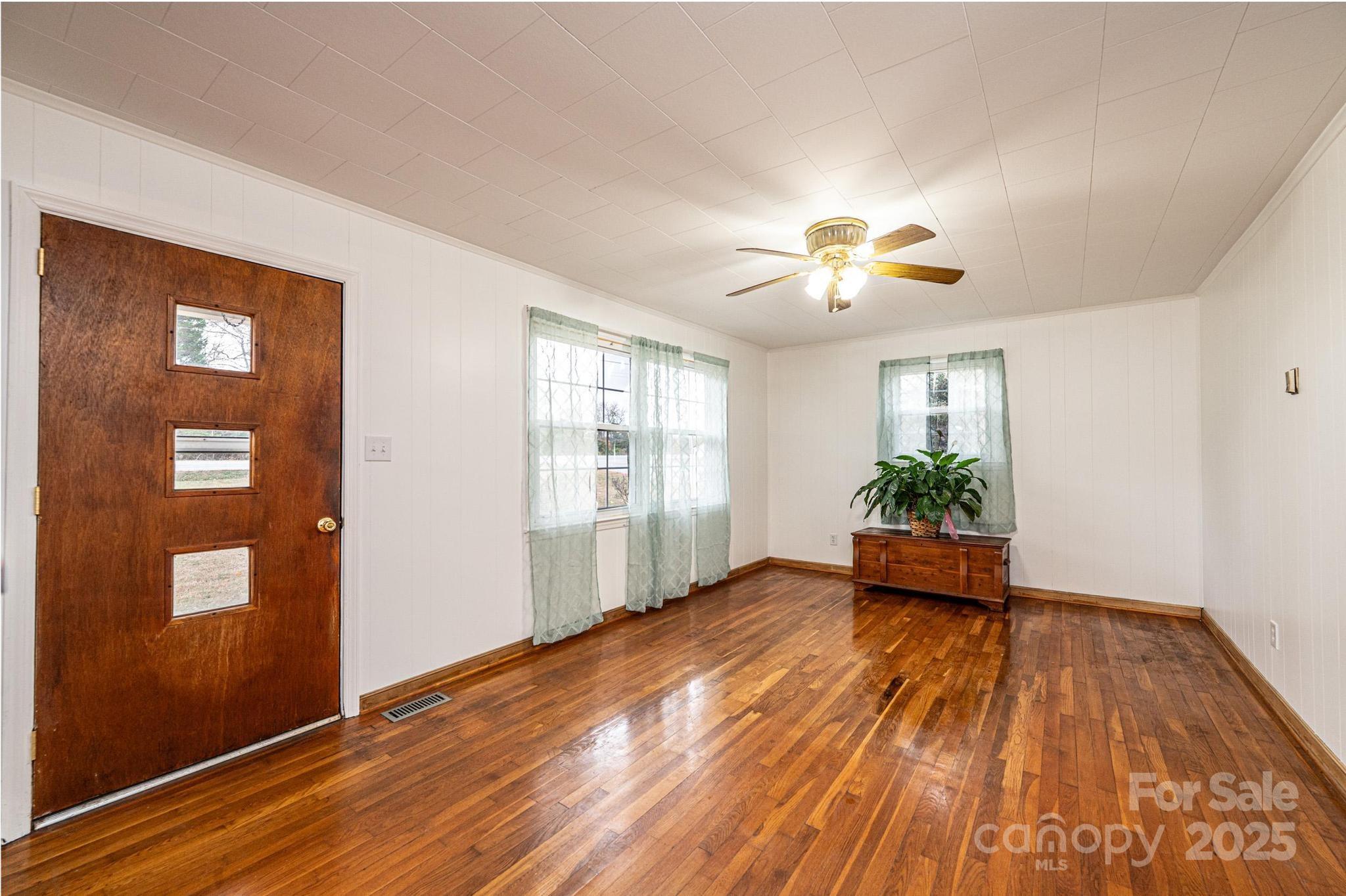 1214 Dry Ponds Road Granite Falls, NC 28630 - Photo 6 of 39 a view of an empty room with window and wooden floor