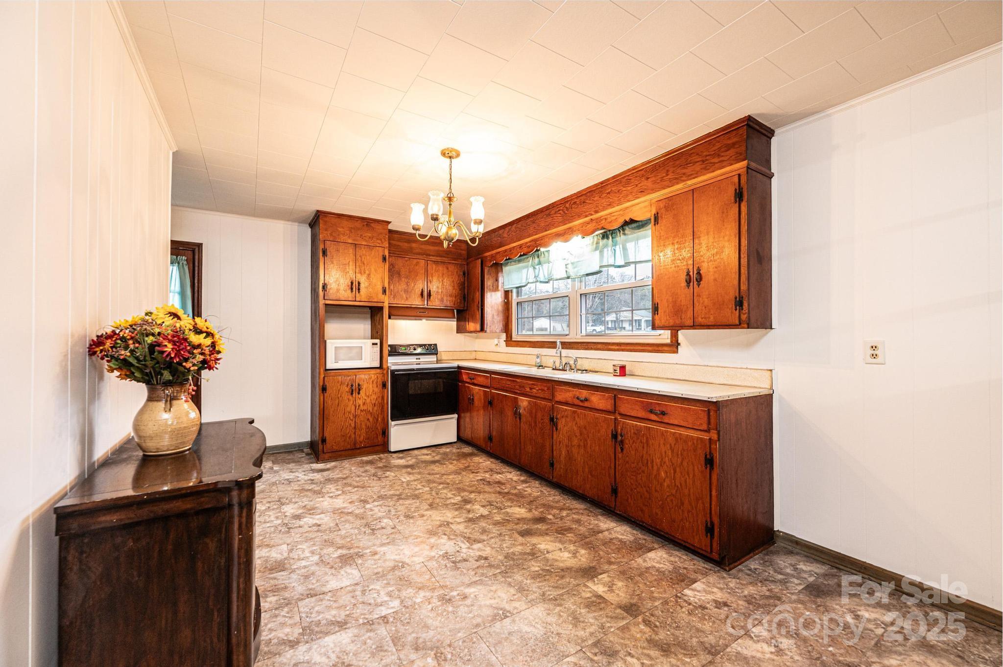 1214 Dry Ponds Road Granite Falls, NC 28630 - Photo 7 of 39 a kitchen with stainless steel appliances kitchen island granite countertop a sink and cabinets