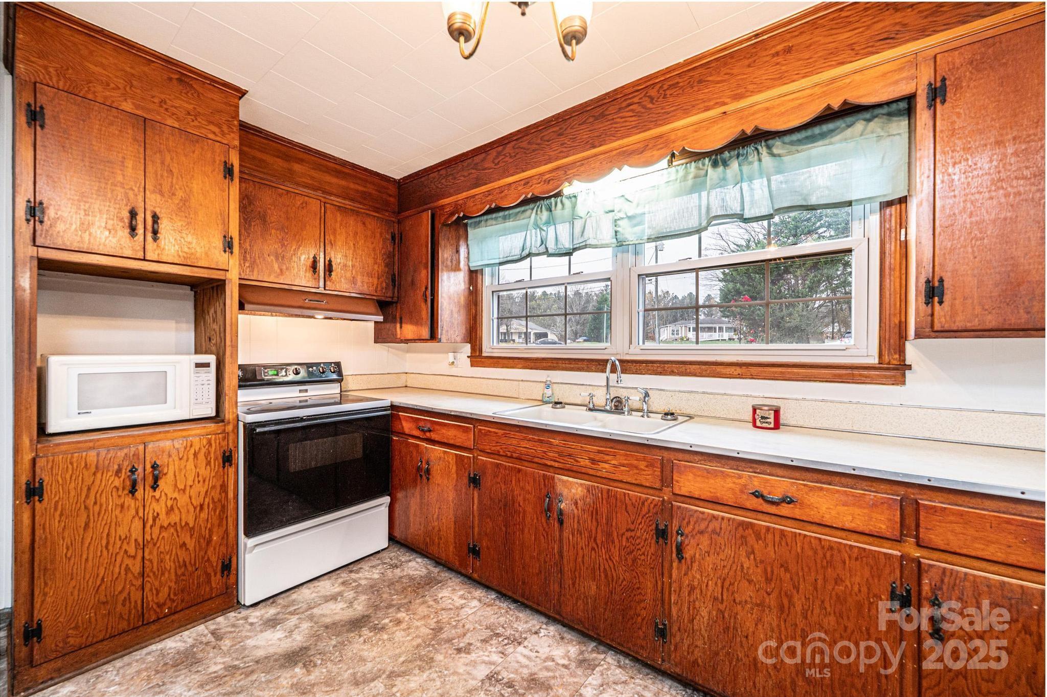 1214 Dry Ponds Road Granite Falls, NC 28630 - Photo 8 of 39 a kitchen with stainless steel appliances granite countertop a sink and a stove