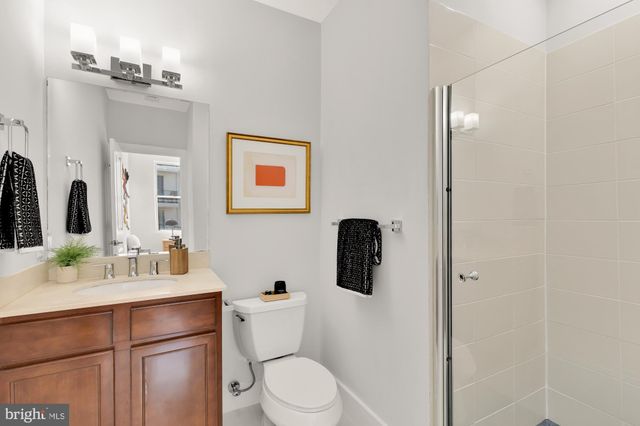 a bathroom with a sink vanity mirror and toilet