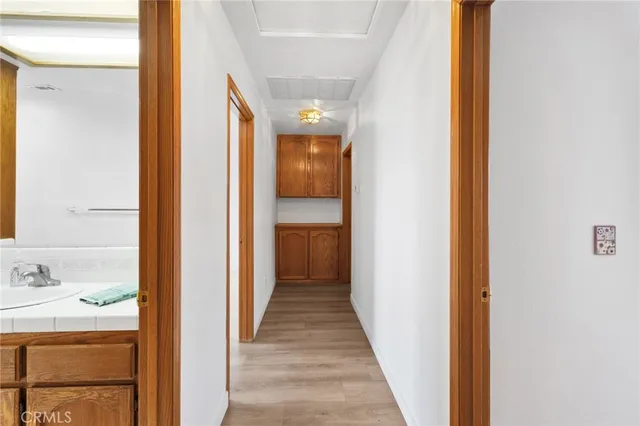 a view of a hallway with a closet and mirror