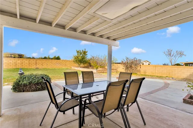 a view of a patio with a table and chairs