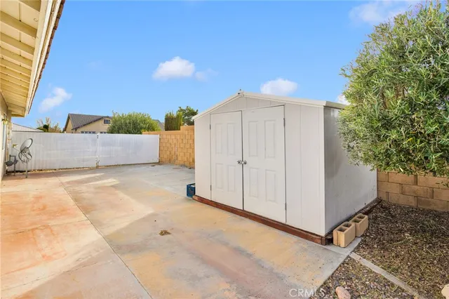 a view of a room with a tub and tree in the background