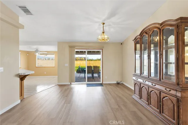 a view of a hallway with wooden floor and windows