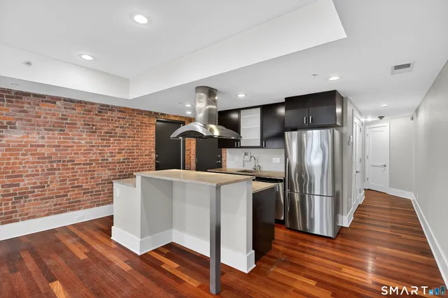 a kitchen with a sink and wooden floor