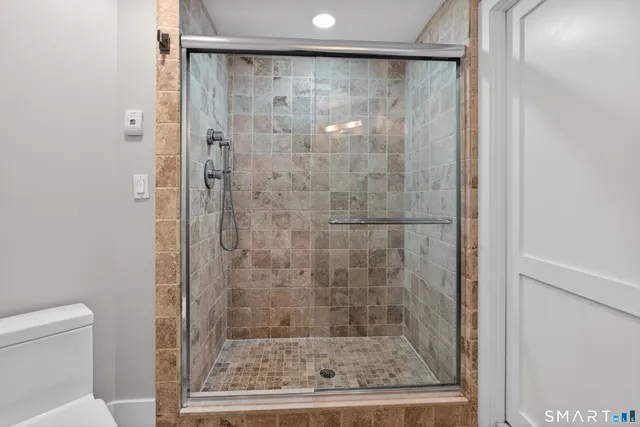 a bathroom with a sink a chair and a mirror