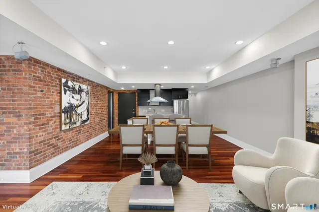 a kitchen with stainless steel appliances granite countertop a stove and a wooden floors