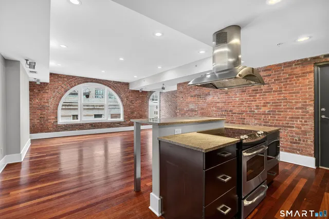 a view of empty room with wooden floor and window