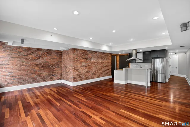 a view of kitchen space wooden floor and electronic appliances