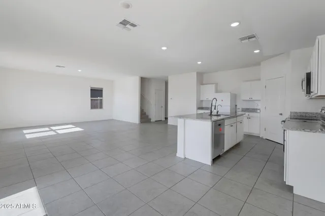 a kitchen with stainless steel appliances a refrigerator sink and cabinets
