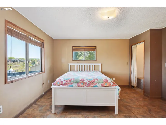 a room with bed and window