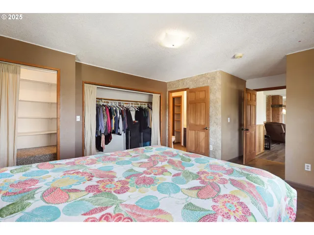 a bedroom with a bed and a large mirror