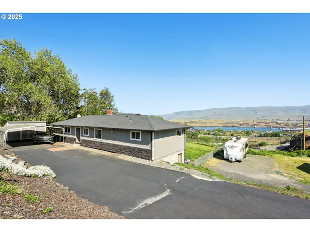 a bathroom with a sink mirror and view of residential buildings