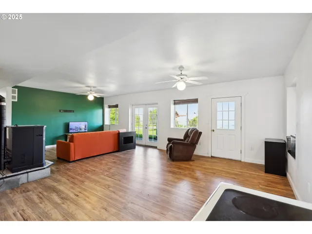 a living room with furniture window and wooden floor