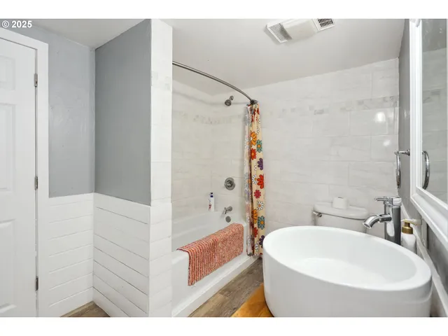 a bathroom with a sink a bathtub and a shower