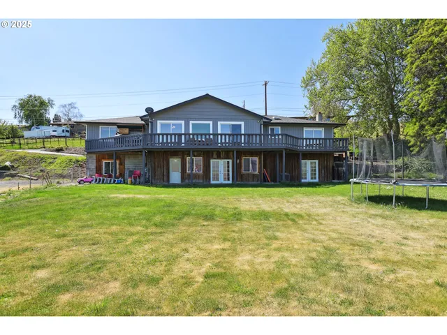 a front view of a house with a yard table and chairs