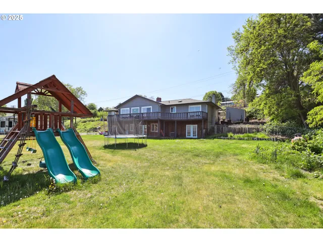 a aerial view of a house with swimming pool and a yard