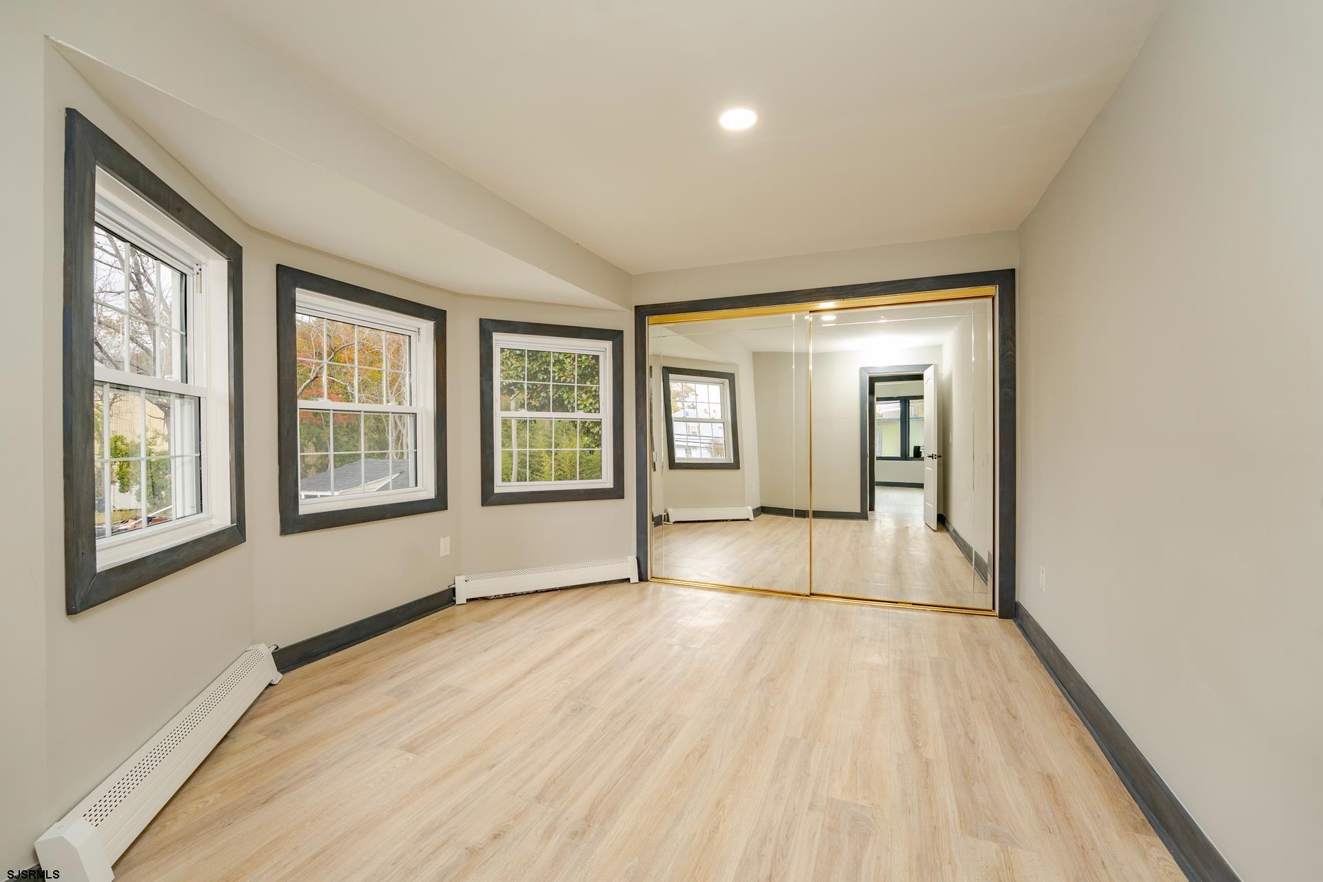 1203 West Mill Road Northfield, NJ 08225 - Photo 21 of 90 a view of empty room with wooden floor and fan