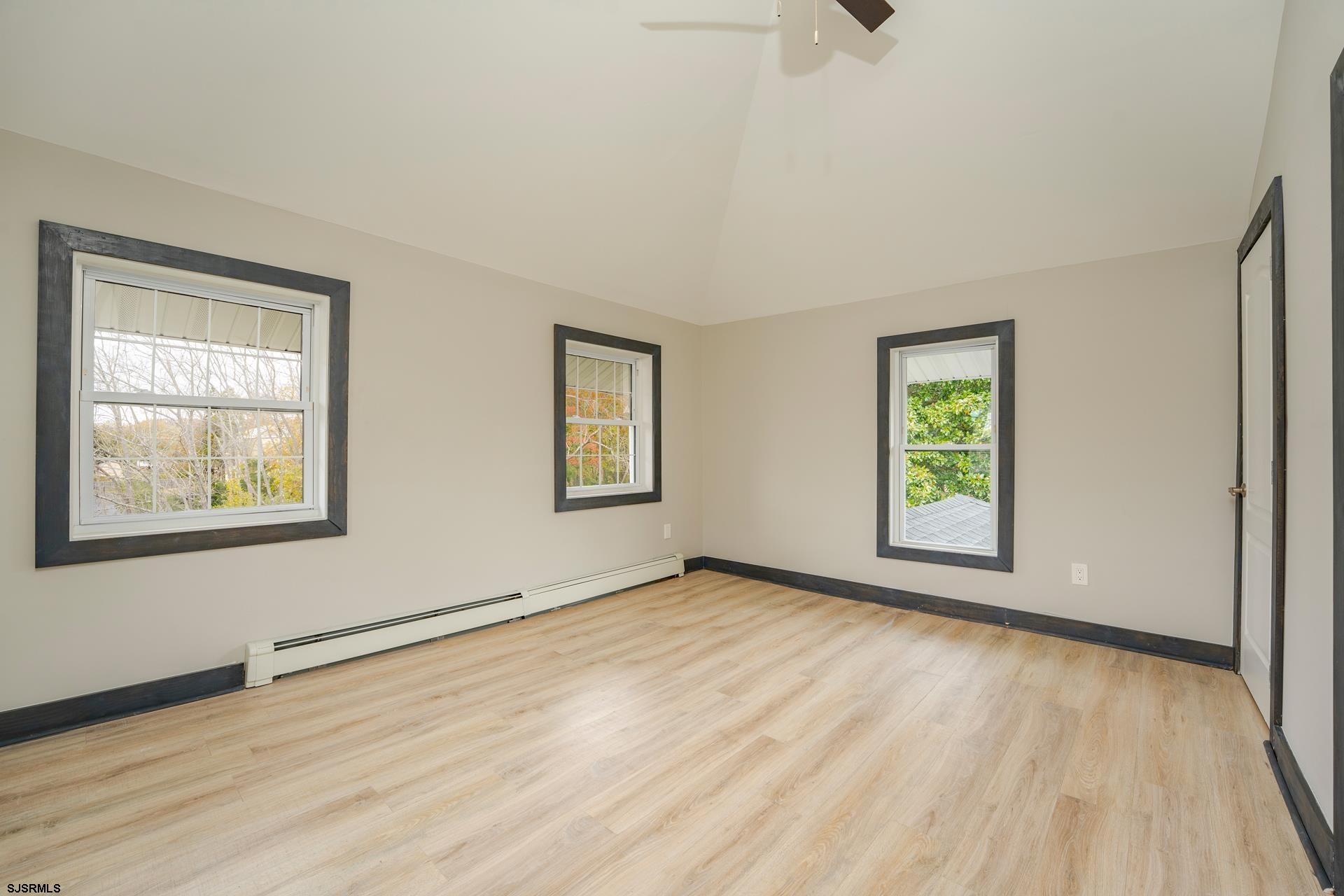 1203 West Mill Road Northfield, NJ 08225 - Photo 27 of 90 a view of an empty room with window and wooden floor