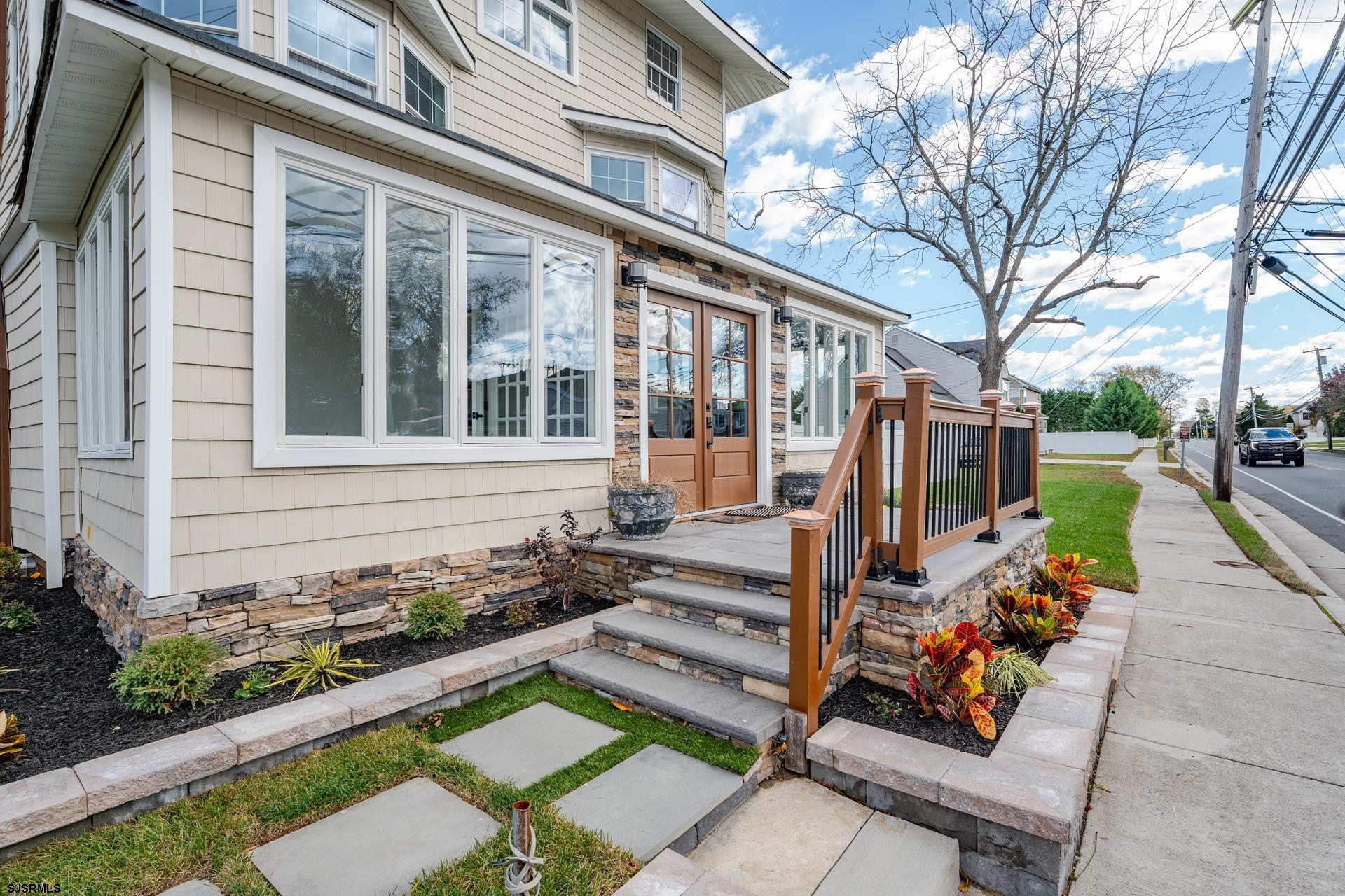 1203 West Mill Road Northfield, NJ 08225 - Photo 3 of 90 a view of a house with a yard and a garden